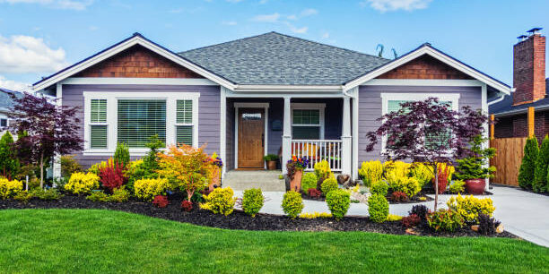 Photo of a modern custom single-level suburban home on a sunny summer day Photo of a modern custom single-level suburban home on a sunny summer day