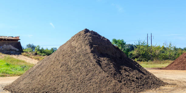 Mound of black Soil used for landscaping and driveways on display and for sale.